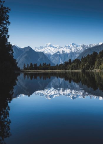 Lake surrounded by mountains and forest birthday card