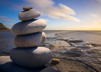 Stones stacked up on rock near the sea birthday card