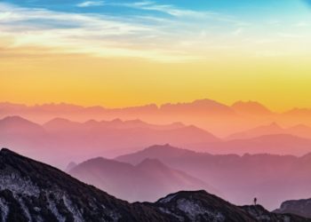 Colourful sky over mountain range birthday card