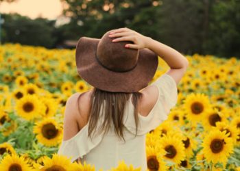 Female standing among sunflowers birthday card